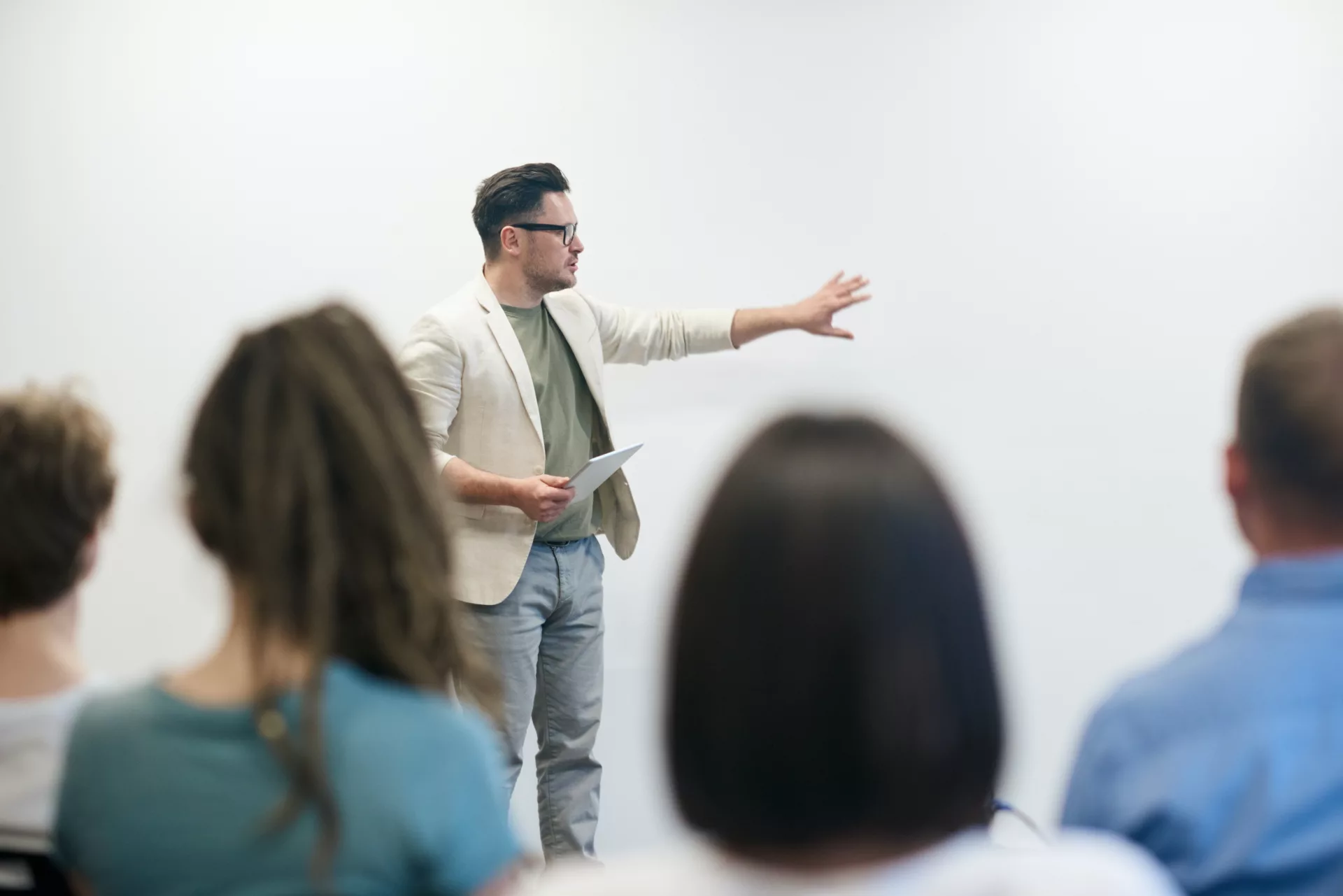 man standing in front of students teaching