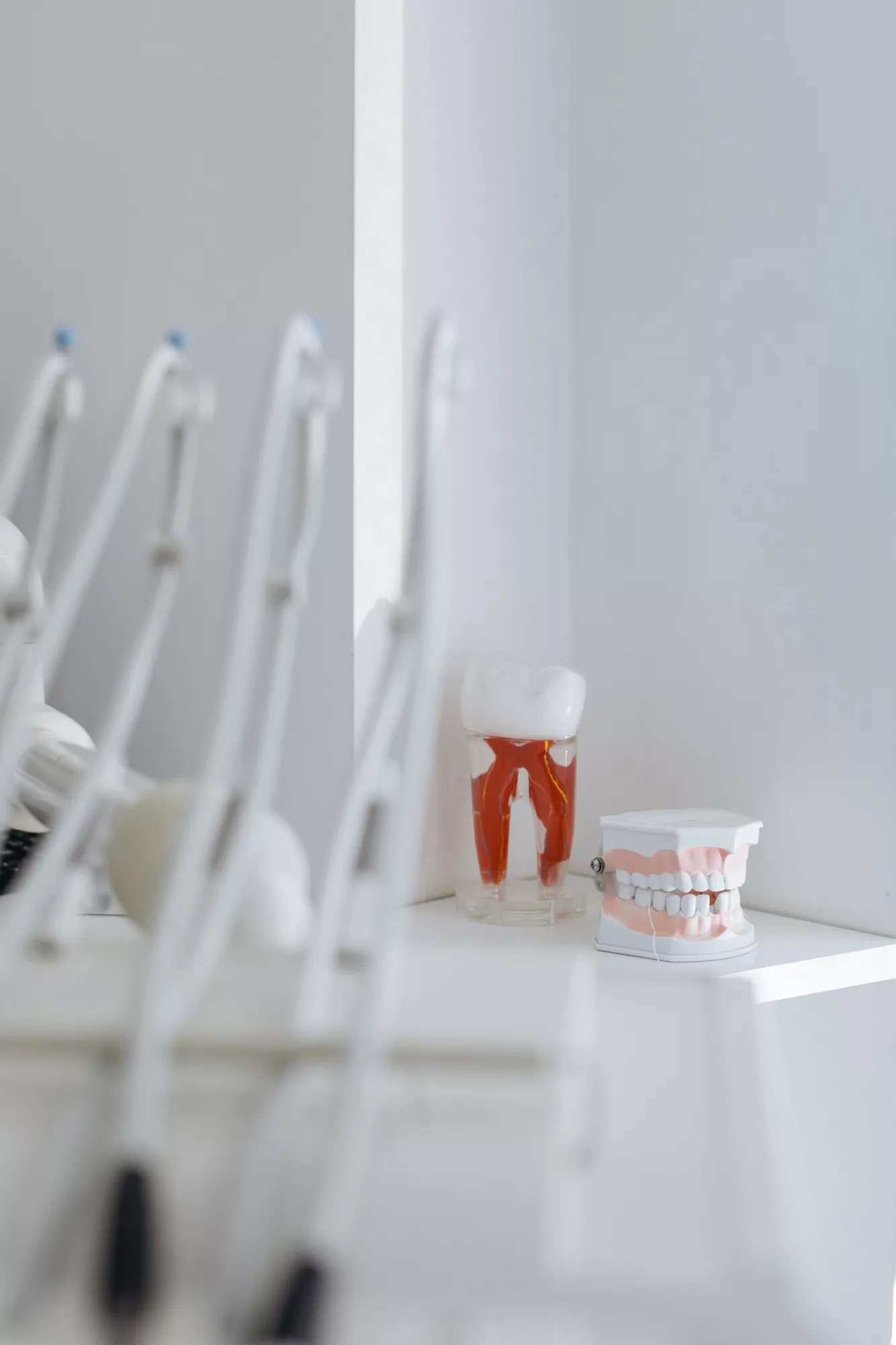 A white wall with a sink and toothbrush, creating a clean and hygienic environment for personal care.