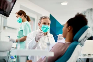 dentist cleaning a patients teeth