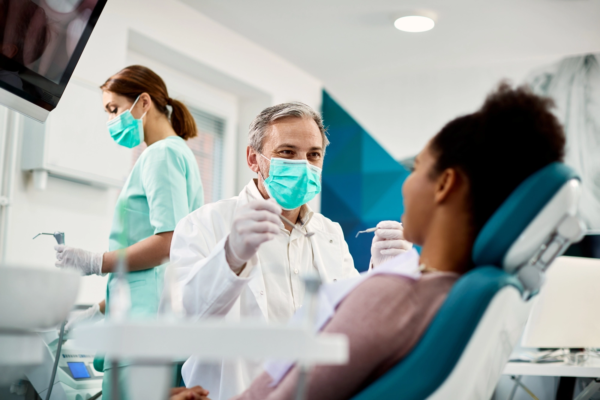 dentist cleaning a patients teeth